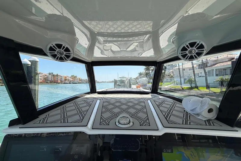 Slide: The Image of Interior view of a 2020 Streamline 45 boat, showcasing dashboard and waterfront scenery. - 59
