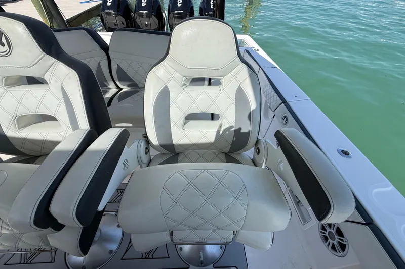 Slide: The Image of Luxurious seating on a 2020 Streamline 45 boat, featuring elegant stitching and armrests. - 64