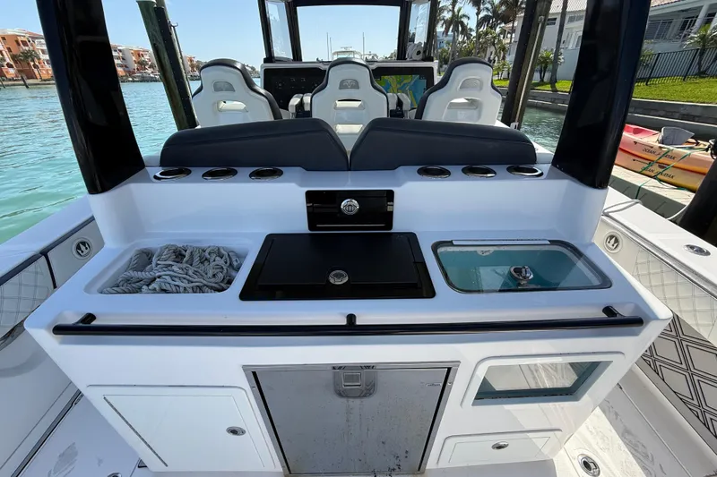 Slide: The Image of Streamline 45 boat interior with seating, storage, and control panel, docked by the water. - 66