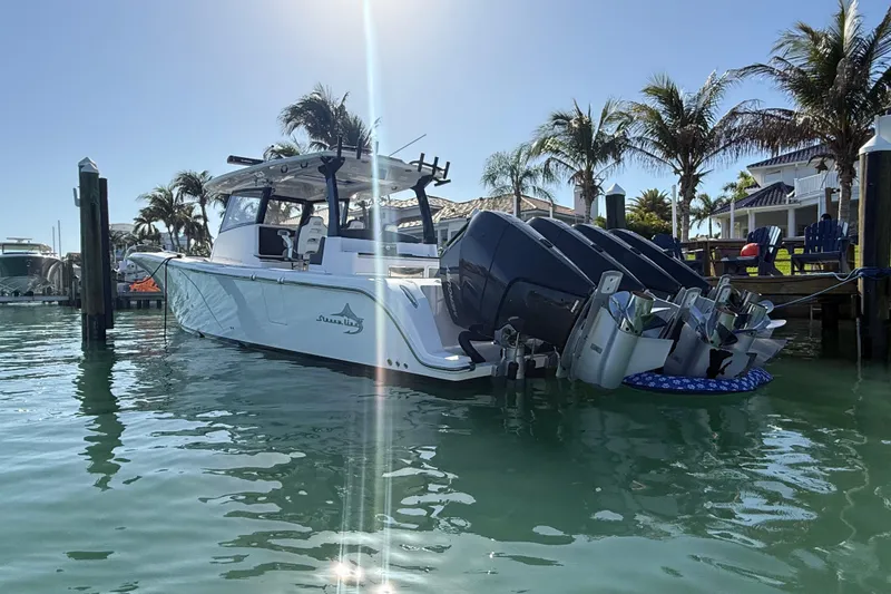 Slide: The Image of Streamline 45 boat docked in sunny marina, surrounded by palm trees, 2020 model. - 7