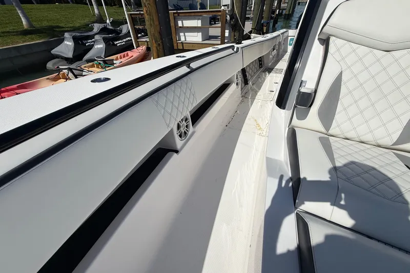 Slide: The Image of 2020 Streamline 45 boat interior with white quilted seats and speaker detail. - 81