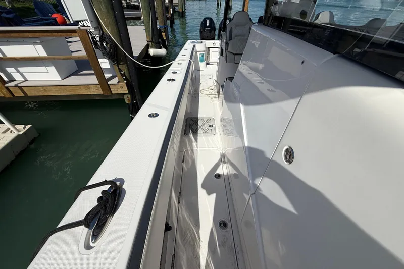 Slide: The Image of 2020 Streamline 45 boat docked, showcasing sleek white deck and modern design. - 82