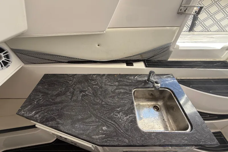Slide: The Image of Streamline 45 boat kitchen with marble countertop and stainless steel sink, 2020 model. - 88