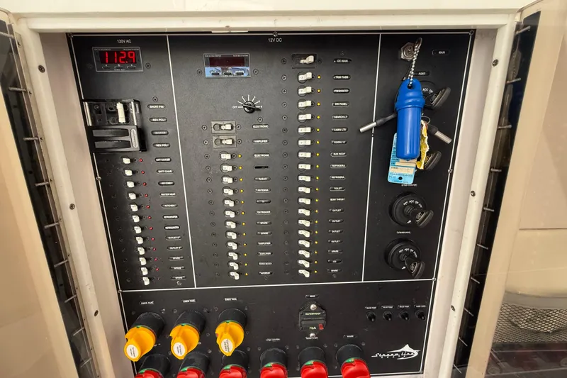 Slide: The Image of Electrical control panel of a 2020 Streamline 45, featuring switches and gauges. - 92