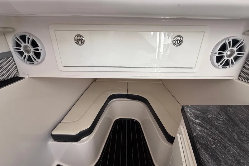 Slide: The Image of 2020 Streamline 45 boat interior with seating, speakers, and storage compartment. - 93