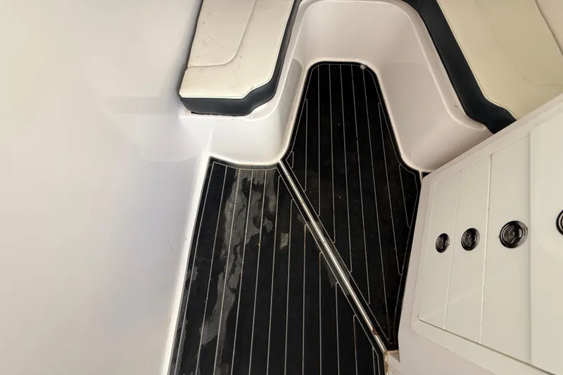 Slide: The Image of Interior of 2020 Streamline 45 boat with sleek black flooring and white seating. - 95