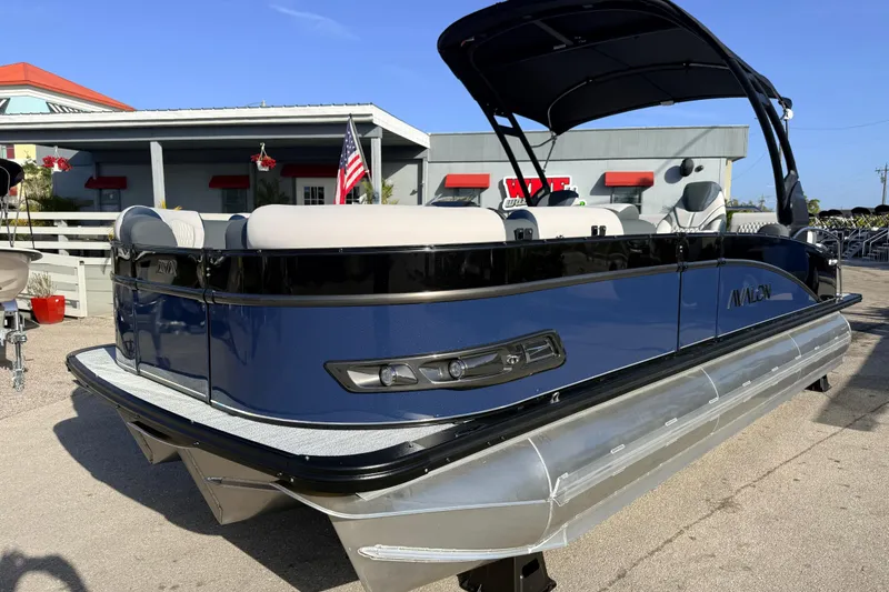 The Image of 2026 Avalon 2385 Catalina Quad Lounger Tri Toon boat, high performance, parked outdoors. - 1