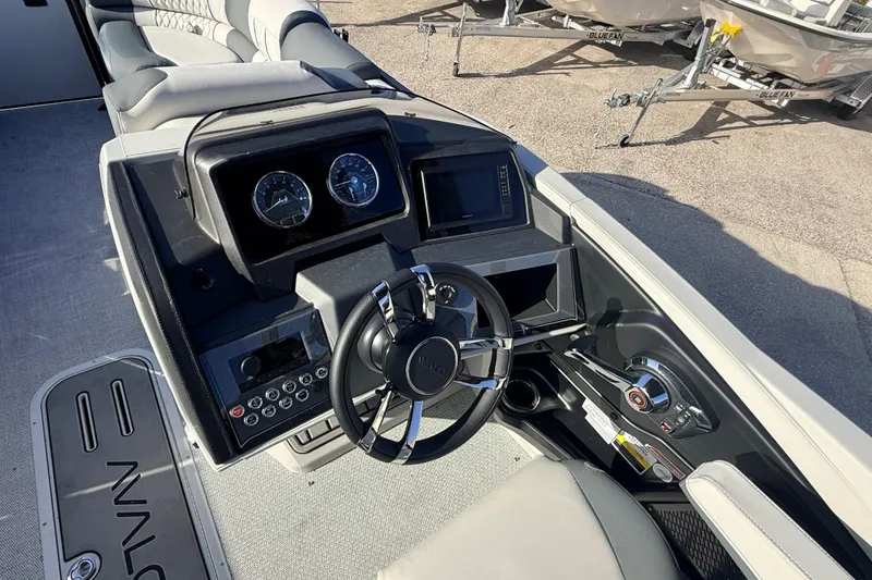 Slide: The Image of 2026 Avalon 2385 Catalina Quad Lounger dashboard with steering wheel and controls, high-performance tri-toon. - 23