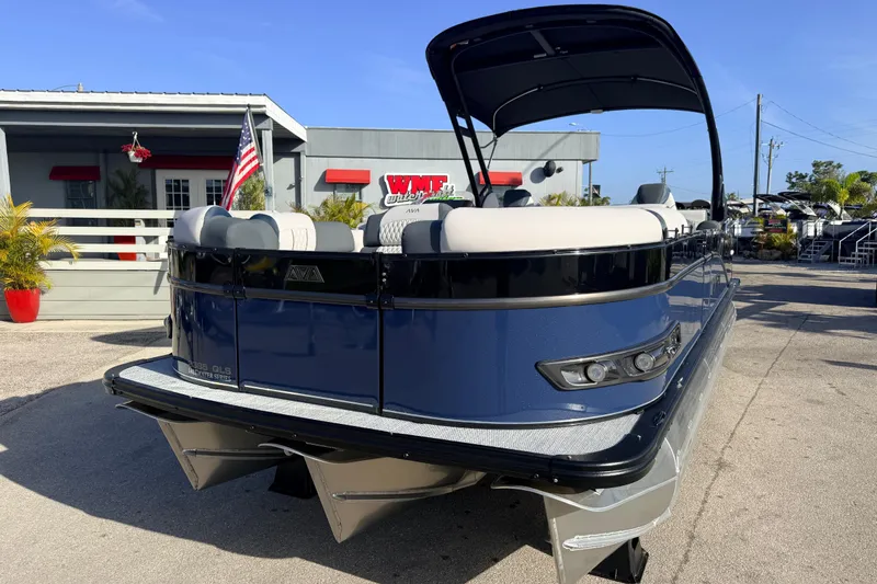 Slide: The Image of 2026 Avalon 2385 Catalina Quad Lounger Tri Toon boat, high performance, parked outdoors. - 3