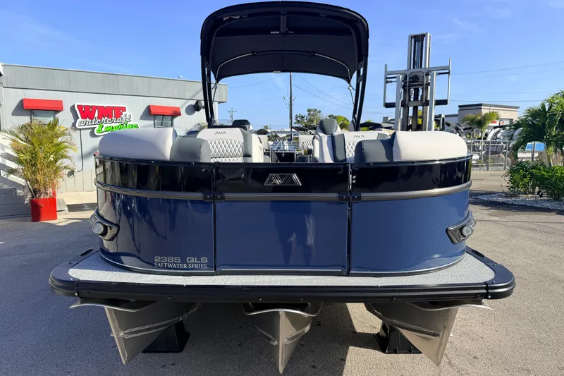 Slide: The Image of 2026 Avalon 2385 Catalina Quad Lounger, Tri Toon, high-performance boat in dealership lot. - 4