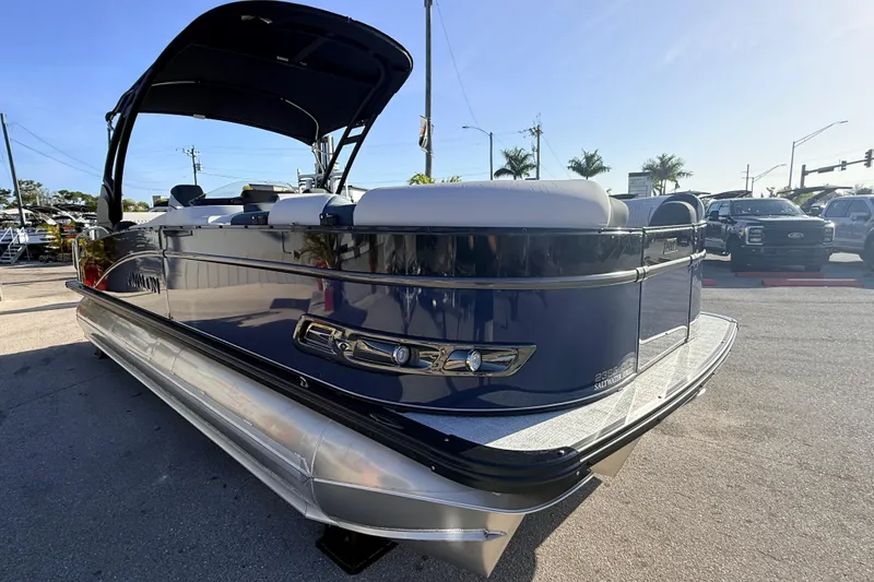 Slide: The Image of 2026 Avalon 2385 Catalina Quad Lounger Tri Toon boat, high performance, parked outdoors. - 5