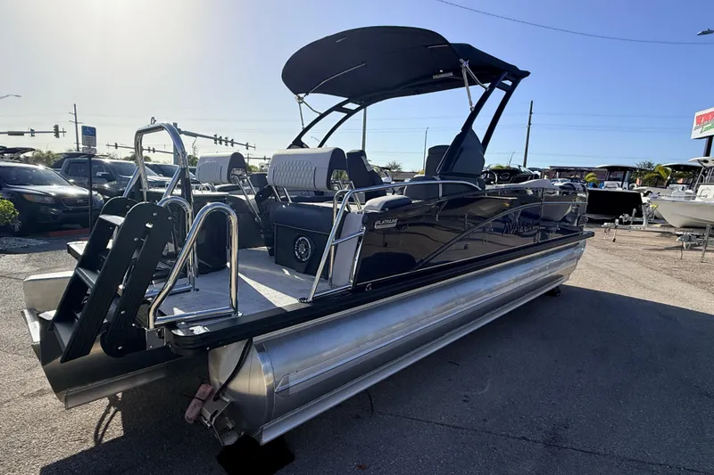 Slide: The Image of 2026 Avalon 2385 Catalina Quad Lounger, Tri Toon, high-performance boat in a parking lot. - 6