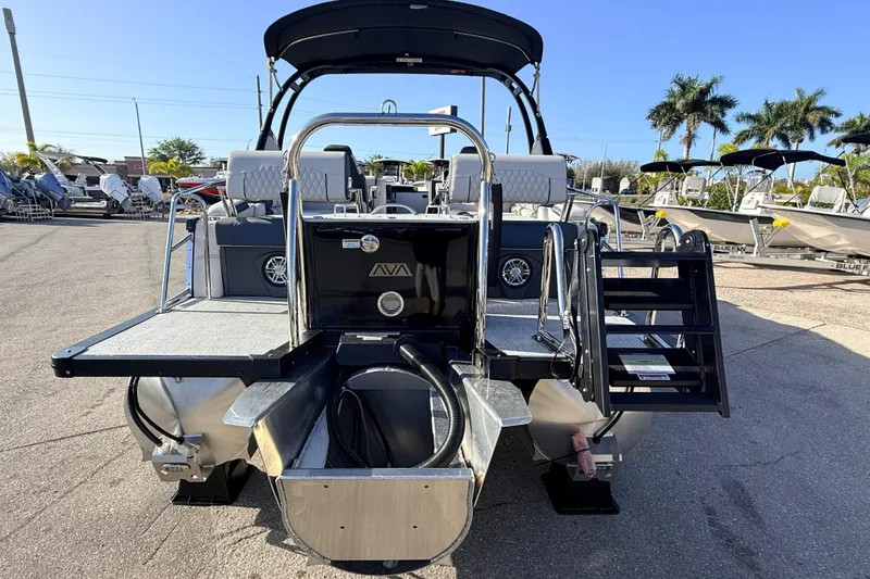 Slide: The Image of 2026 Avalon 2385 Catalina Quad Lounger, Tri Toon, high-performance boat, rear view in marina. - 7