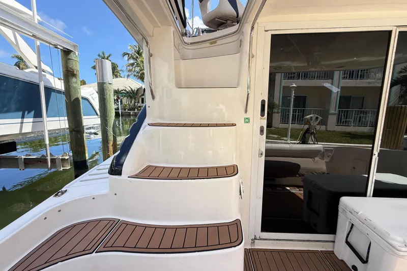 Slide: The Image of 1998 Sea Ray 400 Sedan Bridge yacht with wooden steps and sliding glass door. - 14
