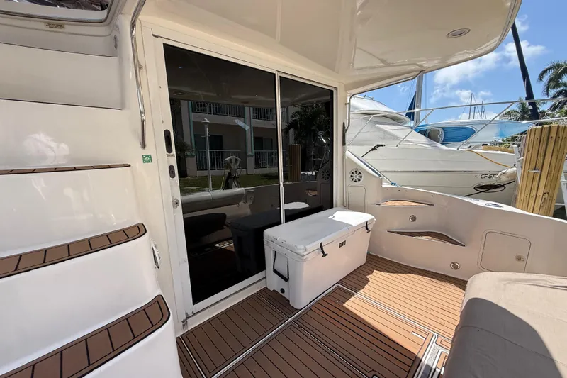 Slide: The Image of 1998 Sea Ray 400 Sedan Bridge yacht deck with seating and cooler. - 16