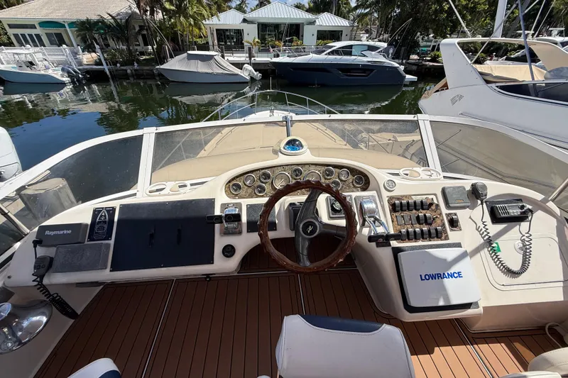 Slide: The Image of Cockpit view of a 1998 Sea Ray 400 Sedan Bridge yacht with navigation equipment. - 21
