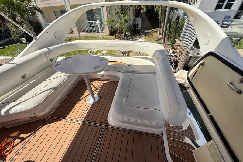 Slide: The Image of 1998 Sea Ray 400 Sedan Bridge yacht with spacious seating and table on deck. - 22