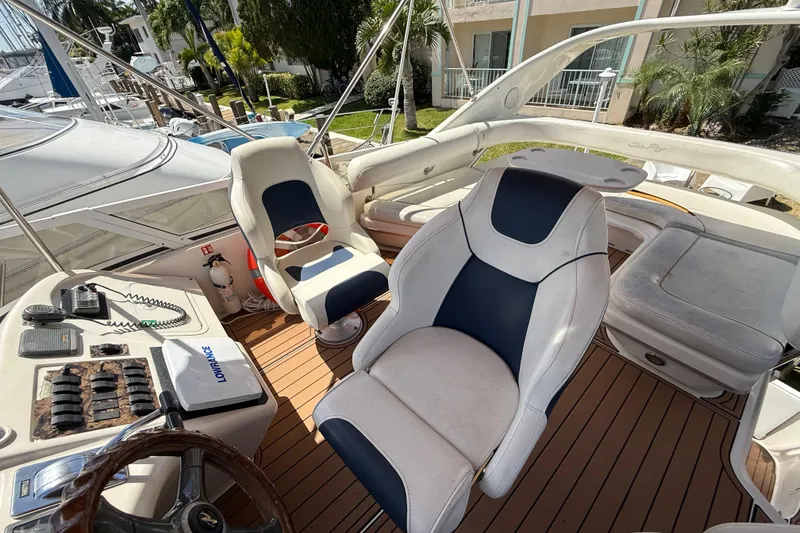 Slide: The Image of 1998 Sea Ray 400 Sedan Bridge cockpit with helm, seating, and control panel. - 24