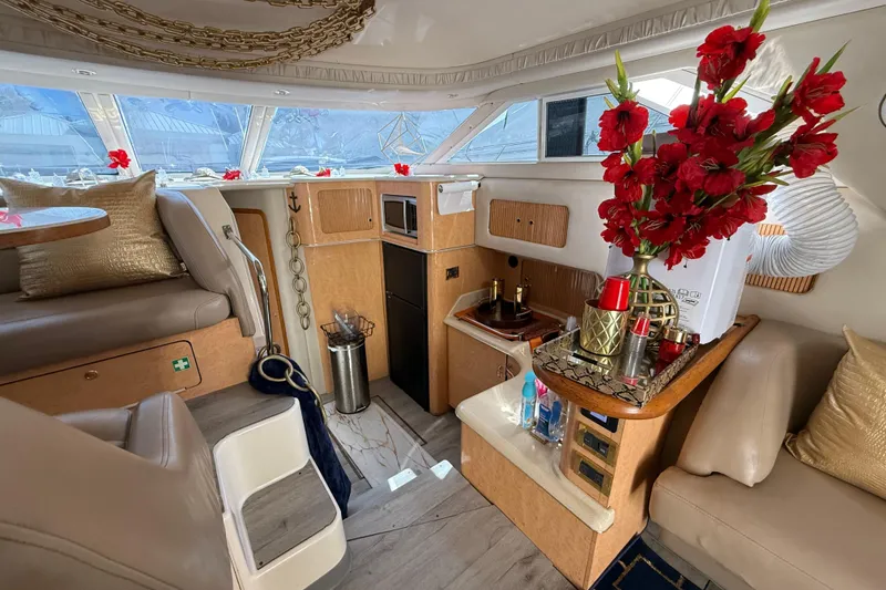 Slide: The Image of Luxurious interior of 1998 Sea Ray 400 Sedan Bridge with elegant decor and red flowers. - 31