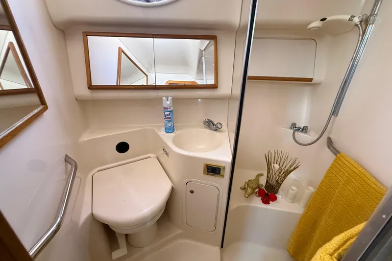 Slide: The Image of Bathroom interior of 1998 Sea Ray 400 Sedan Bridge yacht, featuring shower and sink. - 38