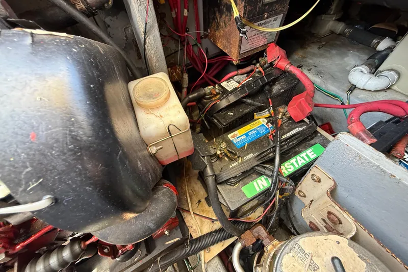 Slide: The Image of Engine compartment of a 1998 Sea Ray 400 Sedan Bridge with visible battery and wiring. - 44