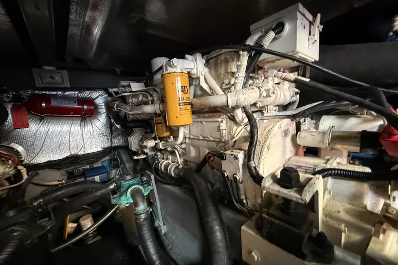 Slide: The Image of Engine room of 1998 Sea Ray 400 Sedan Bridge with visible components and wiring. - 47