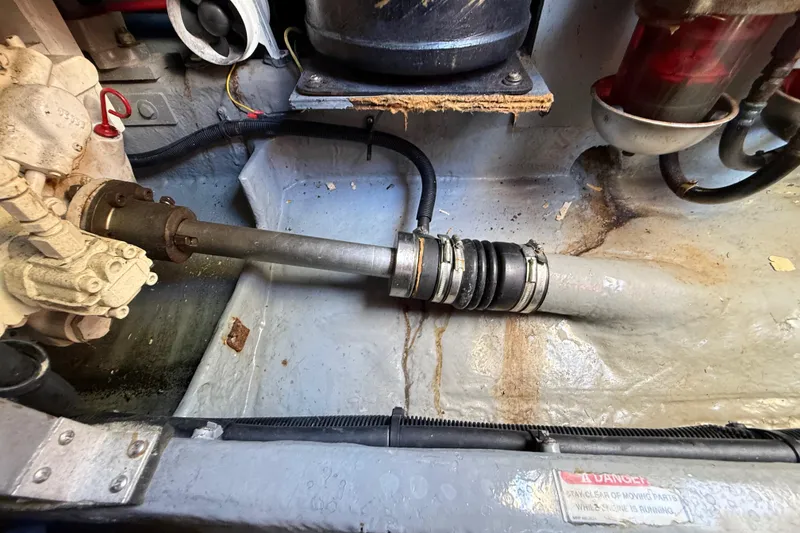 Slide: The Image of Engine compartment of a 1998 Sea Ray 400 Sedan Bridge, showing mechanical components and hoses. - 52