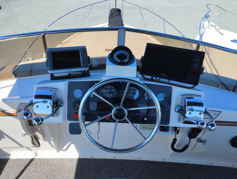 Slide: The Image of 1978 Bertram 33 Convertible helm with steering wheel, gauges, and navigation equipment. - 13