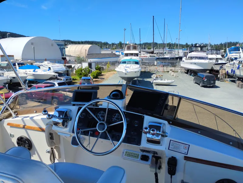 Slide: The Image of Cockpit view of a 1978 Bertram 33 Convertible yacht in a marina. - 14