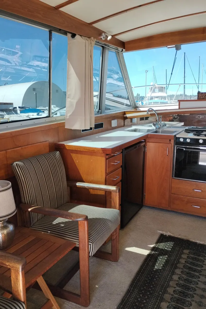 Slide: The Image of Interior of a 1978 Bertram 33 Convertible yacht with kitchen and seating area. - 19