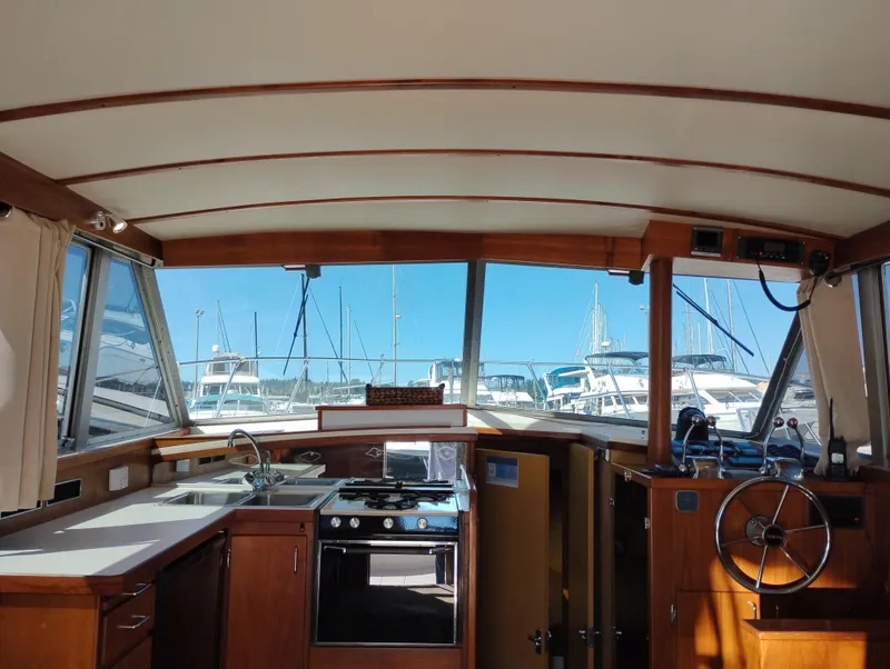 Slide: The Image of Interior of a 1978 Bertram 33 Convertible yacht with kitchen and steering wheel. - 21