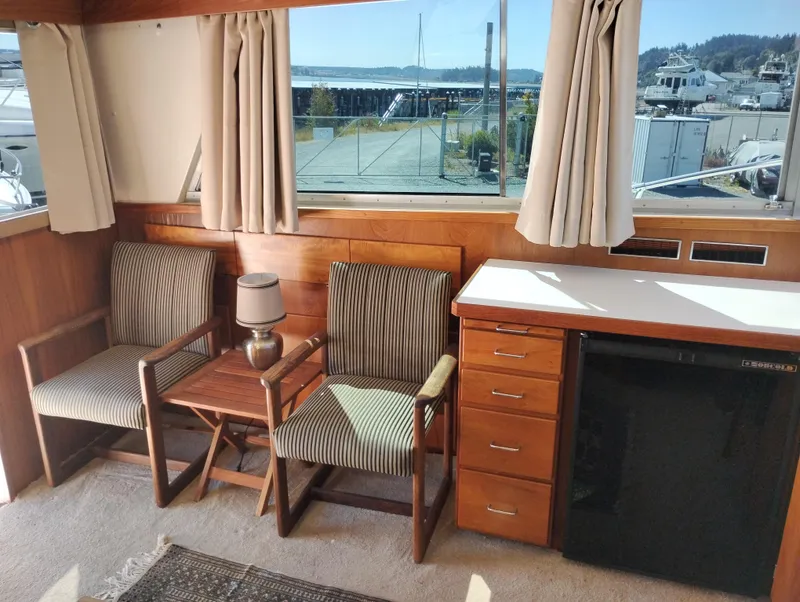 Slide: The Image of Interior of a 1978 Bertram 33 Convertible with chairs, table, and cabinetry. - 22