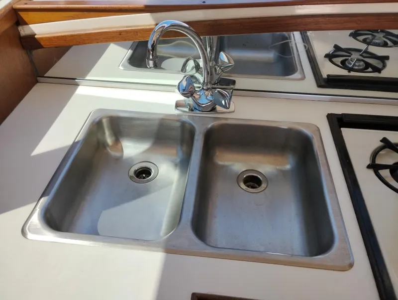 Slide: The Image of Stainless steel double sink in 1978 Bertram 33 Convertible boat kitchen. - 25