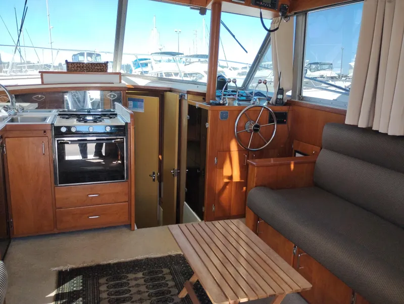 Slide: The Image of Interior of a 1978 Bertram 33 Convertible boat with kitchen and seating area. - 28
