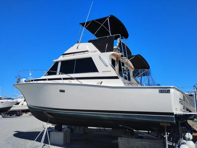 Slide: The Image of 1978 Bertram 33 Convertible boat on dry dock under clear blue sky. - 3