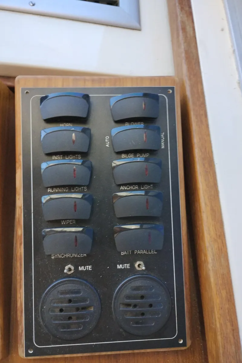 Slide: The Image of Control panel of a 1978 Bertram 33 Convertible boat with various switches and dials. - 33