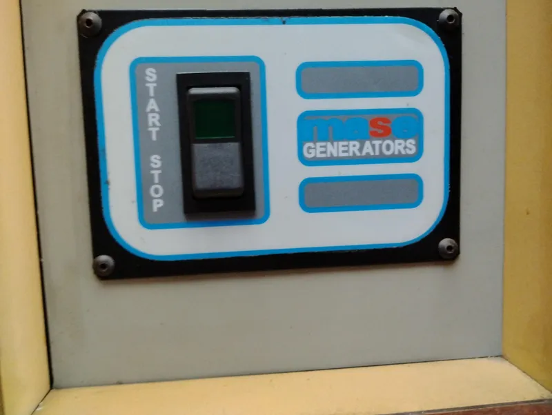 Slide: The Image of Control panel of Mase Generators on a 1978 Bertram 33 Convertible boat. - 36