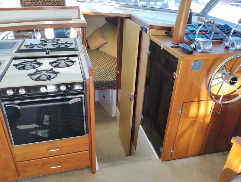 Slide: The Image of 1978 Bertram 33 Convertible interior with kitchen, stove, and helm station. - 38