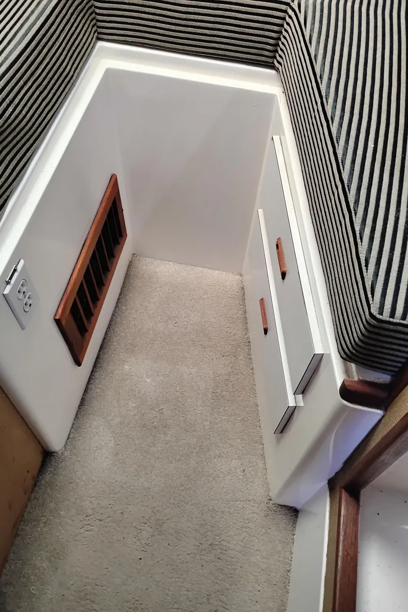 Slide: The Image of Interior of a 1978 Bertram 33 Convertible boat with striped upholstery and wooden accents. - 40