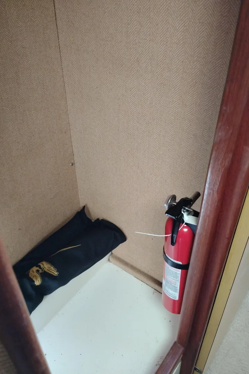 Slide: The Image of 1978 Bertram 33 Convertible interior with fire extinguisher and rolled-up fabric. - 45