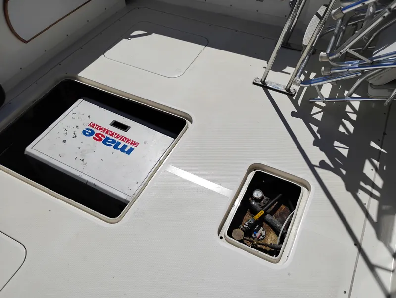 Slide: The Image of 1978 Bertram 33 Convertible boat deck with storage compartments and generator. - 7