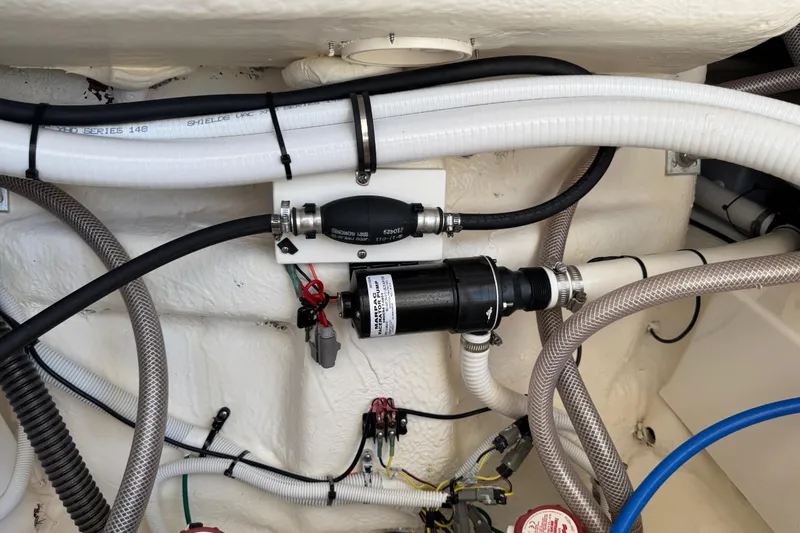 Slide: The Image of 2022 Robalo 266 Cayman boat plumbing system with hoses and fittings. - 100