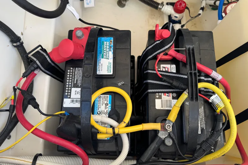 Slide: The Image of Battery setup in a 2022 Robalo 266 Cayman boat with cables and connectors. - 102