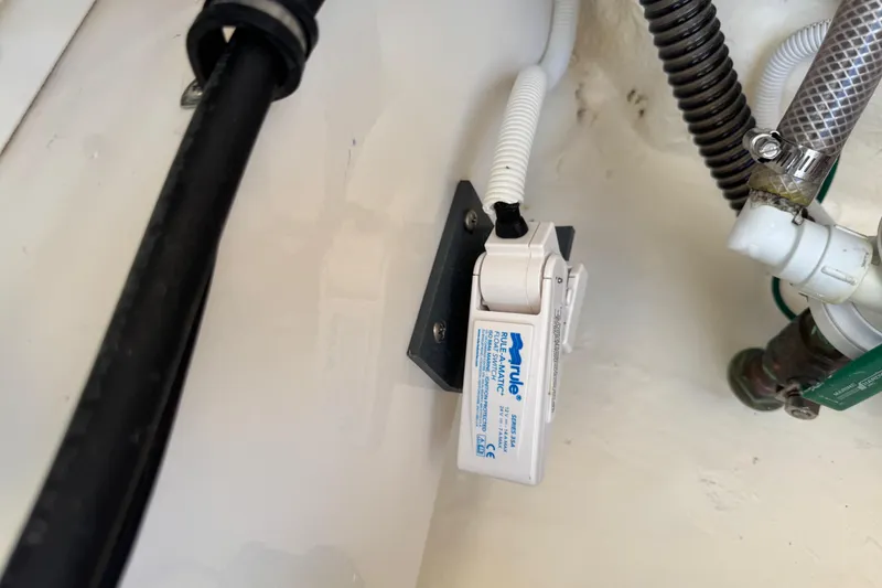 Slide: The Image of 2022 Robalo 266 Cayman boat bilge pump and plumbing components. - 103