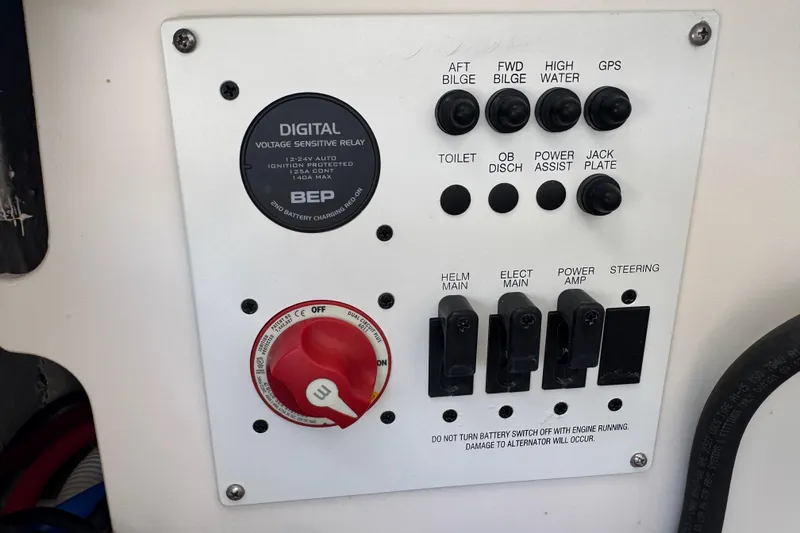 Slide: The Image of Control panel of a 2022 Robalo 266 Cayman boat with switches and voltage relay. - 105