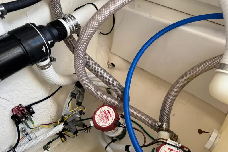 Slide: The Image of 2022 Robalo 266 Cayman boat plumbing and wiring system close-up. - 107