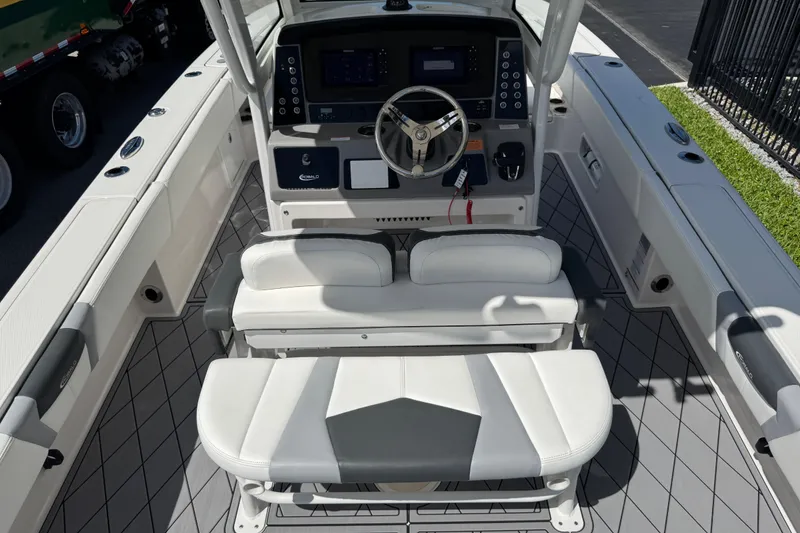 Slide: The Image of 2022 Robalo 266 Cayman boat interior with steering console and seating. - 110