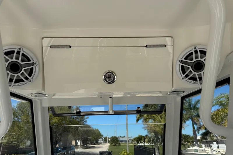 Slide: The Image of 2022 Robalo 266 Cayman boat interior with speakers and storage compartment. - 115