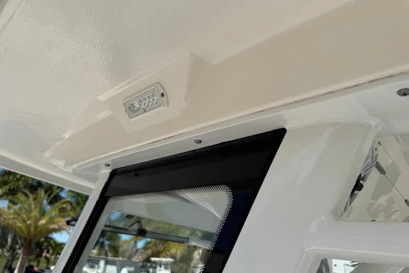 Slide: The Image of 2022 Robalo 266 Cayman boat interior detail with LED light and window. - 116