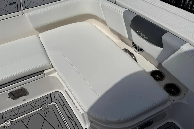 Slide: The Image of 2022 Robalo 266 Cayman boat interior with cushioned seating and cup holders. - 119